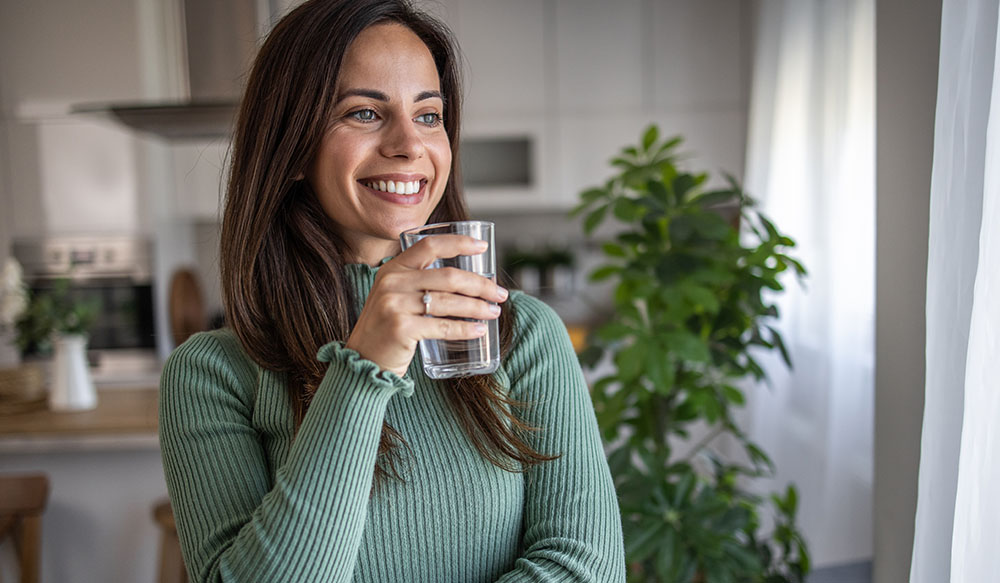 woman drinking tap water flouride