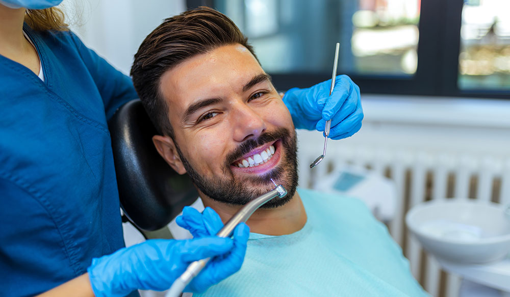 man with veneers at dentist